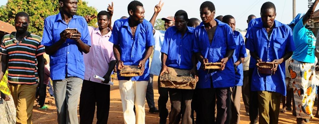 #htmlcaption-0 Men play "Akongo", a traditional music instrument for the Teso people in Serere